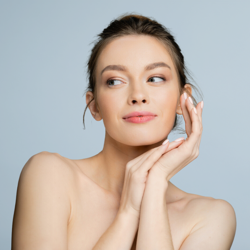 beautiful young woman with her hands on her face