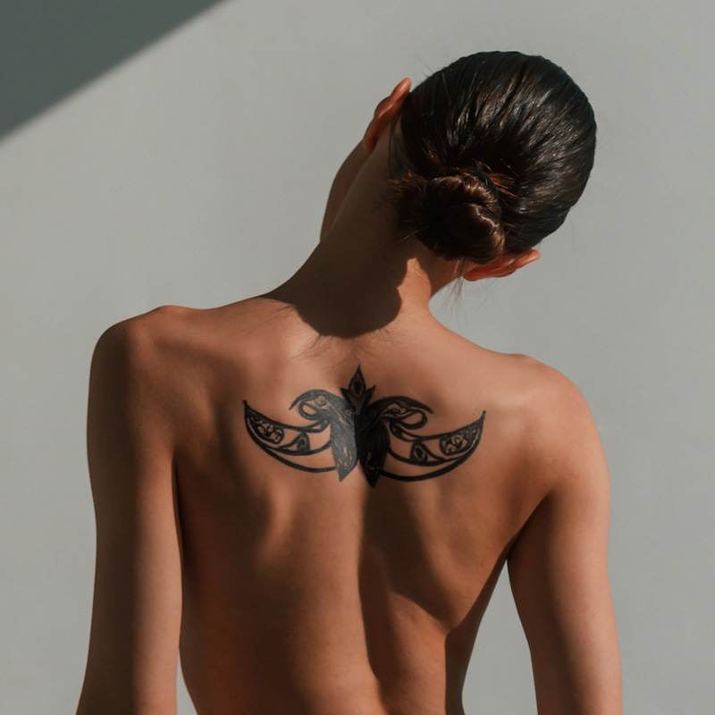 woman with large tattoo on her back