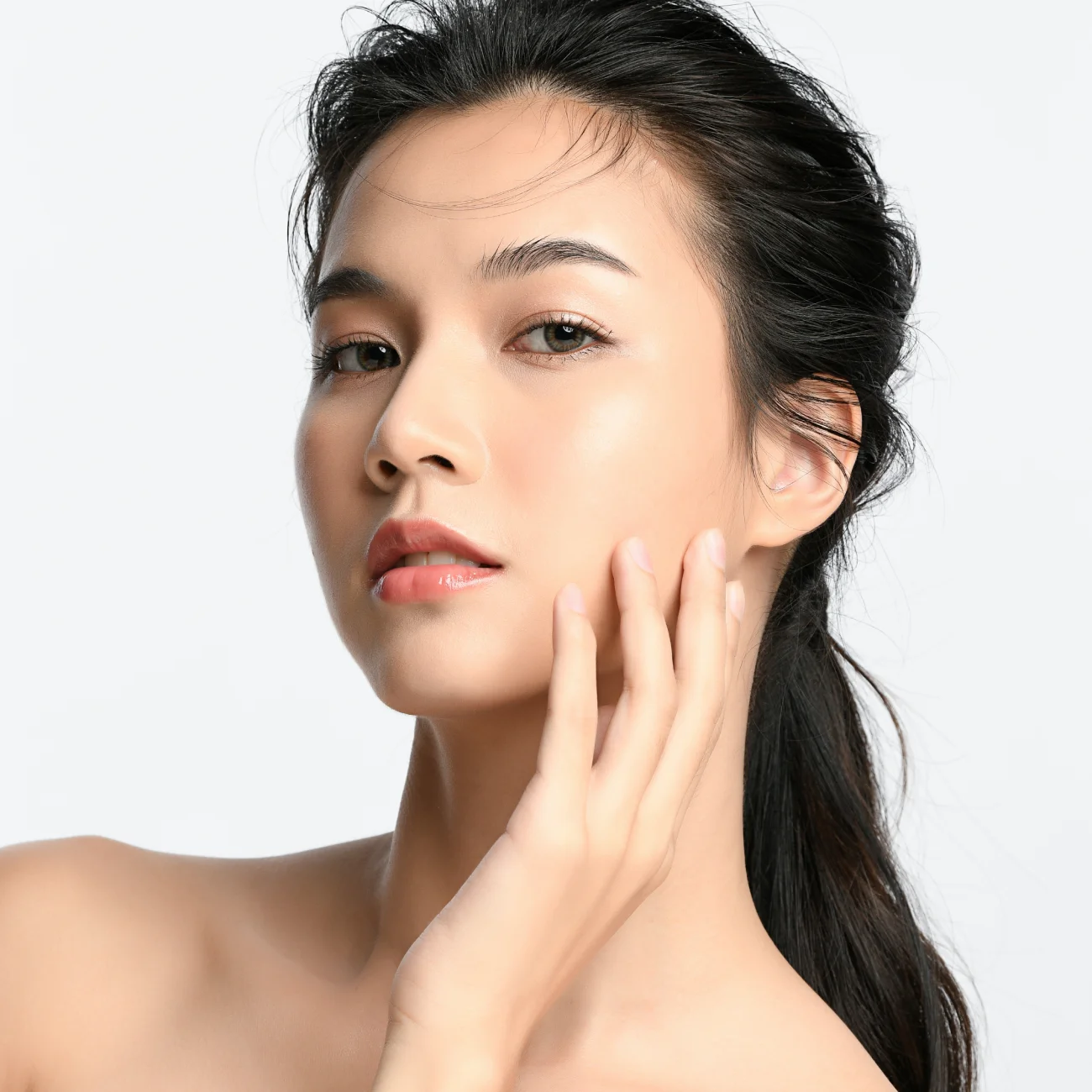 Beautiful young asian woman with clean fresh skin on white background